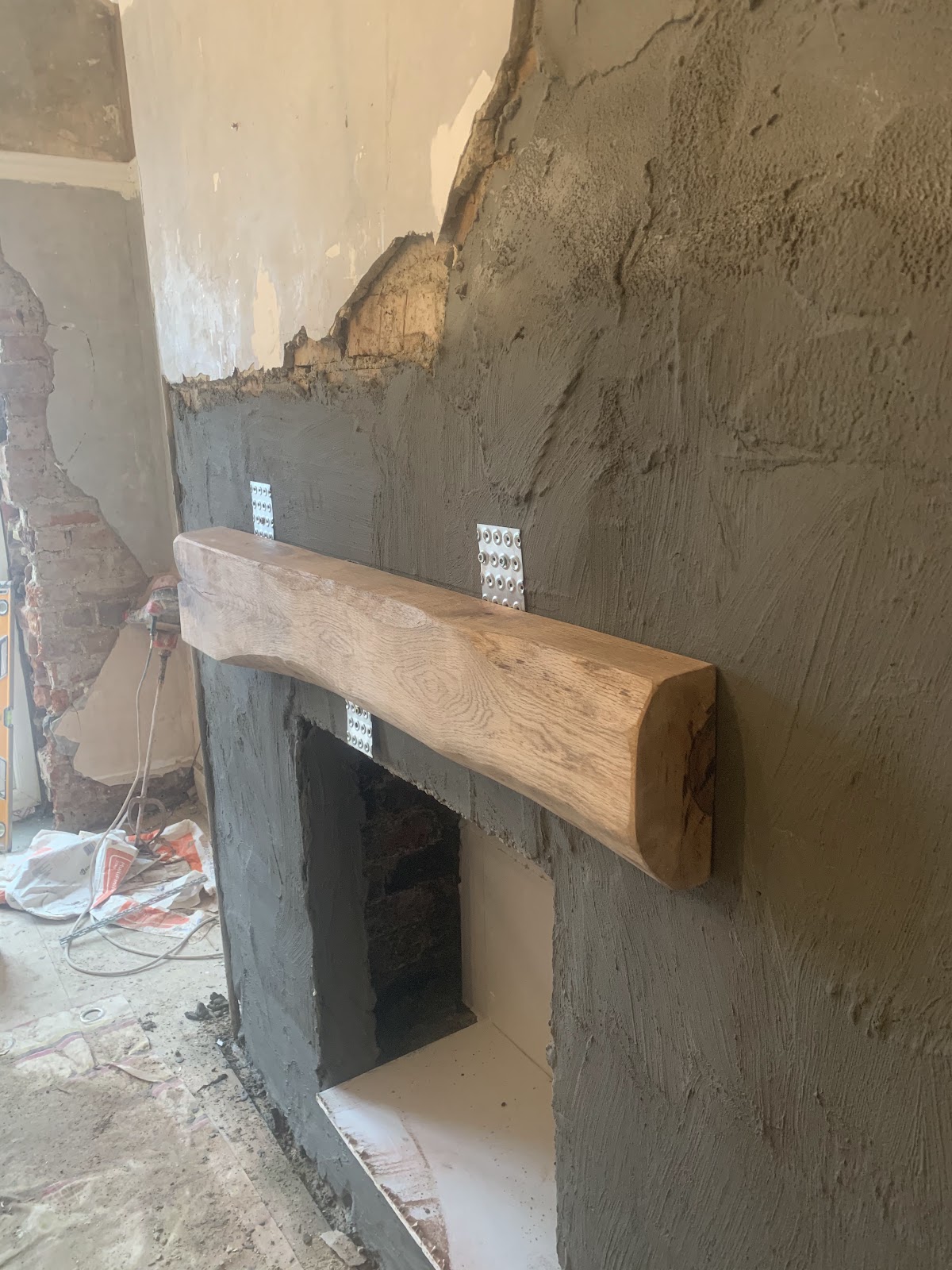 Rendered chimney breast with oak beam mantel